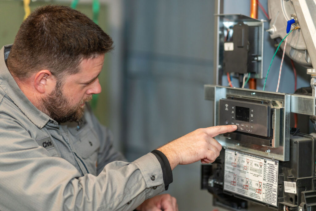 Chris taking a look at an residential HVAC system